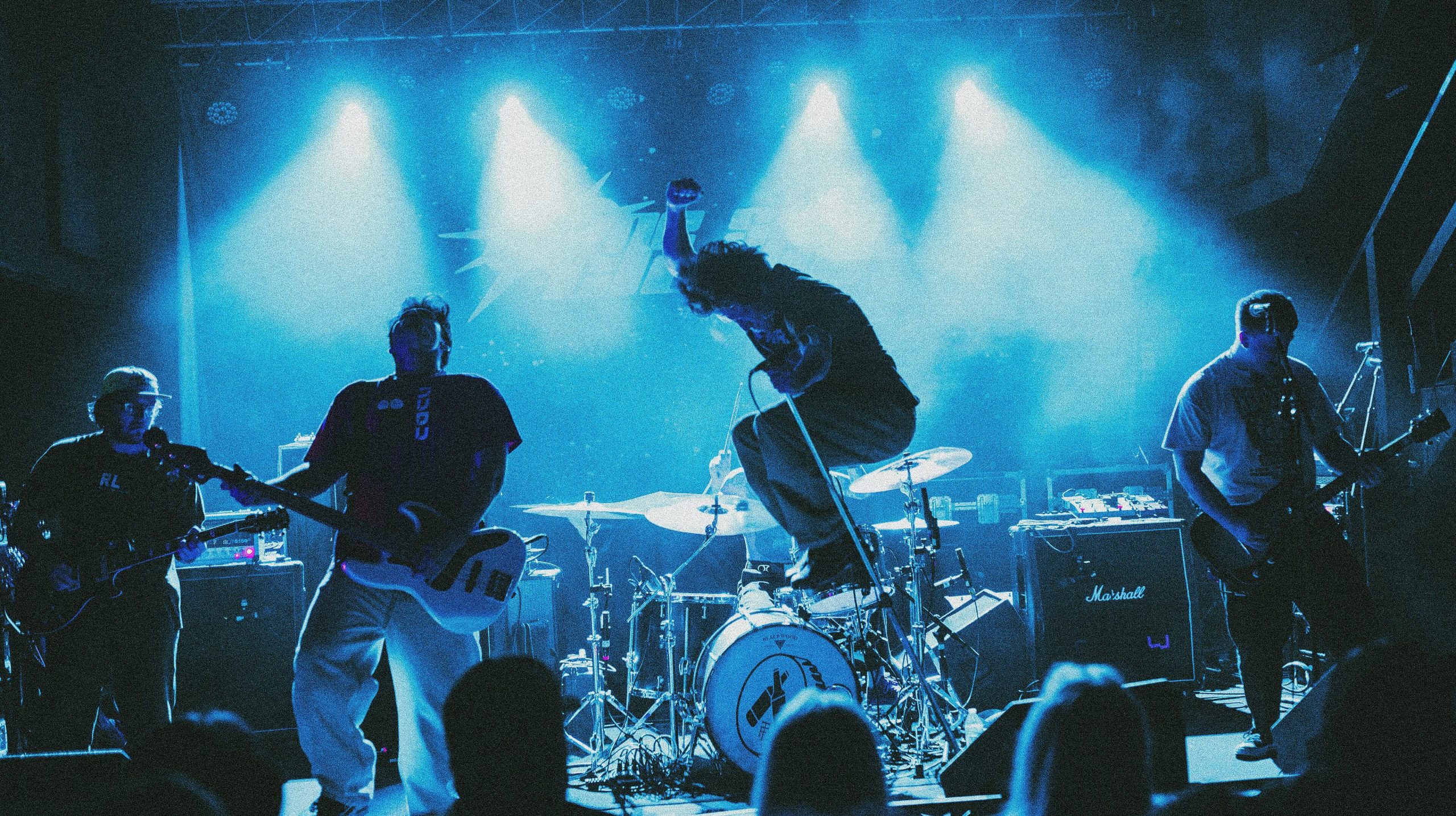 One Step Closer performing on a blue-lit stage