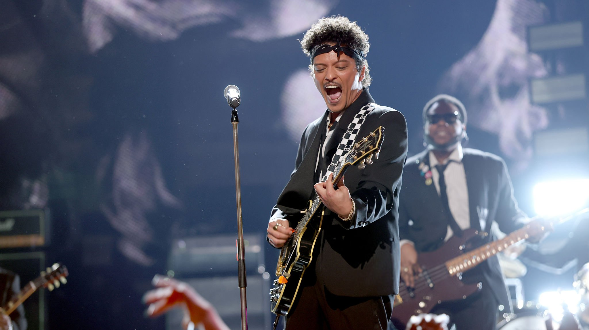 Bruno Mars performs with a guitar at the 2026 Grammy Awards in Los Angeles.