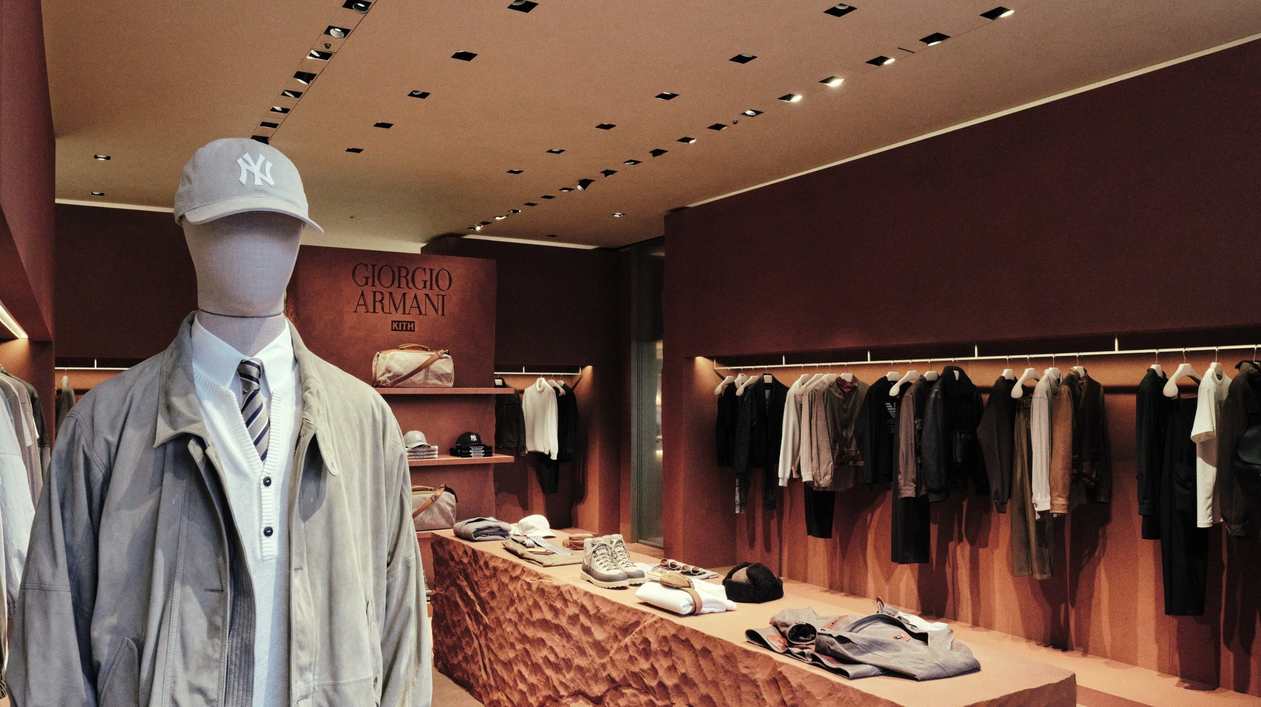 Mannequin in neutral Giorgio Armani & Kith layers and a light Yankees cap at the Omotesando pop-in.